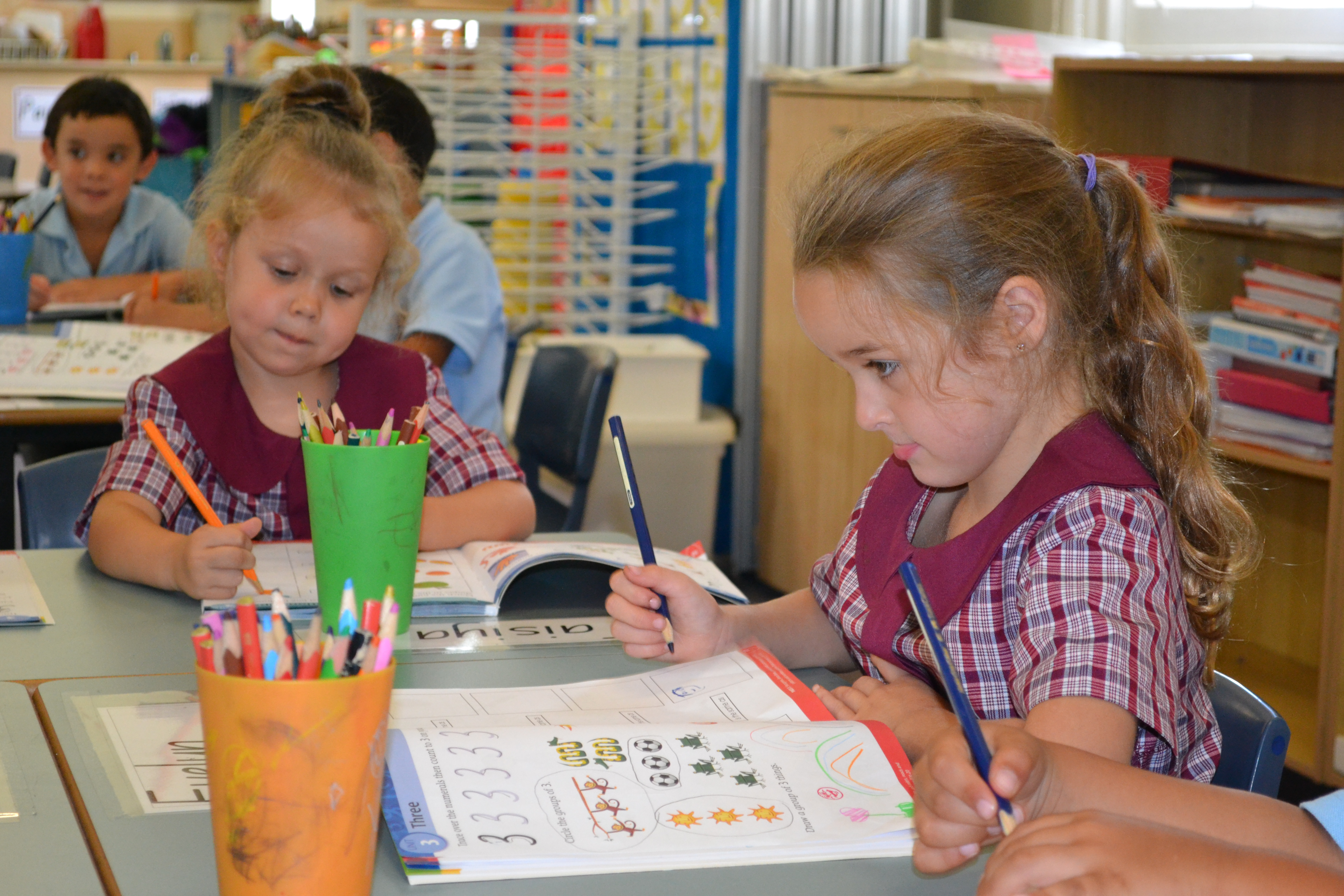 Kindergarten students working at their desk in Term One